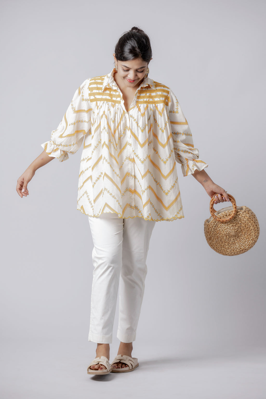 Woman wearing mustard chevron handcrafted peplum cotton top with white trousers