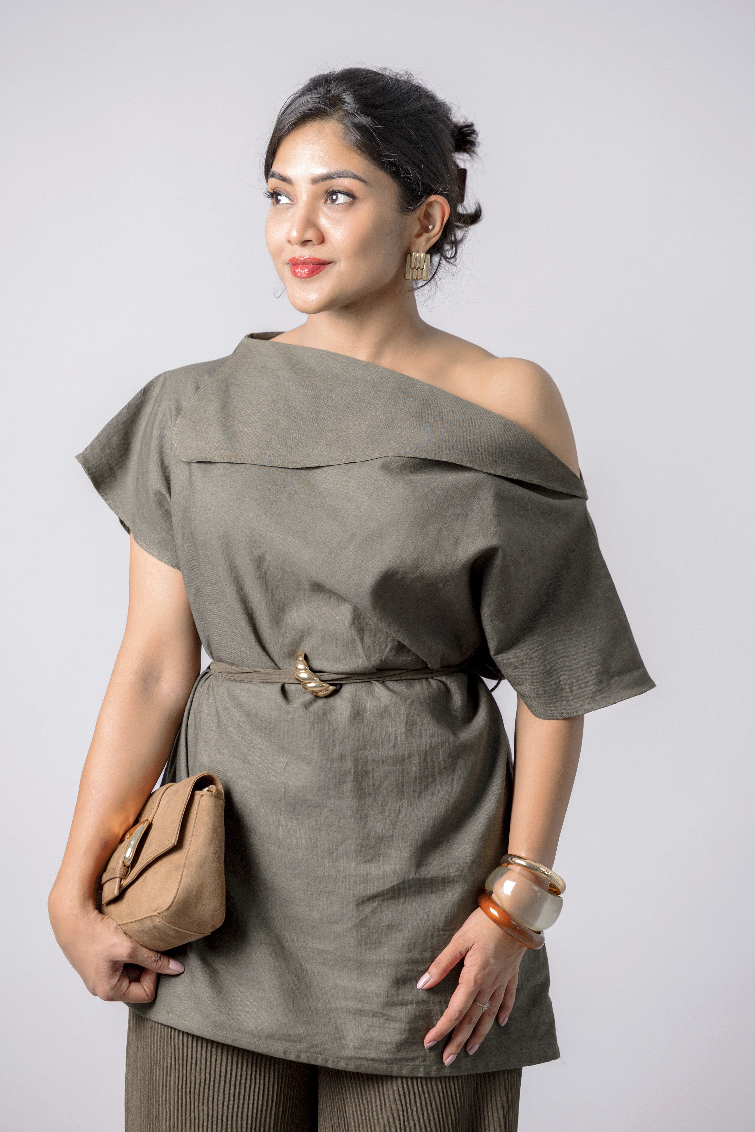 Close-up of olive asymmetric neckline and waist detail on co-ord set